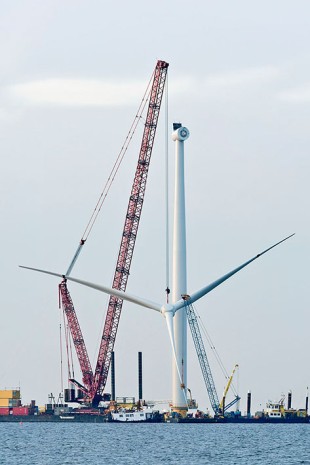 The massive crane required the help of a small ship's crane to pick up the rotor and turn it vertical.