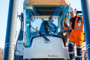 (l-r) His Royal Highness, The Duke of Kent, test drives a Liebherr Reachstacker (LRS 545) crane during his visit to the company’s Sunderland plant.