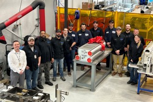 Proud members of the Liebherr Aerospace Saline team with the re-cored heat exchanger